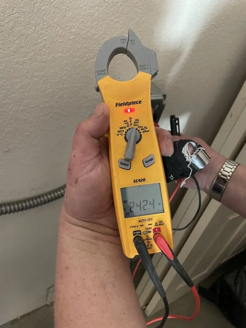 Voltage testing with clamp meter during Ceiling Fan Installation in Bainbridge
